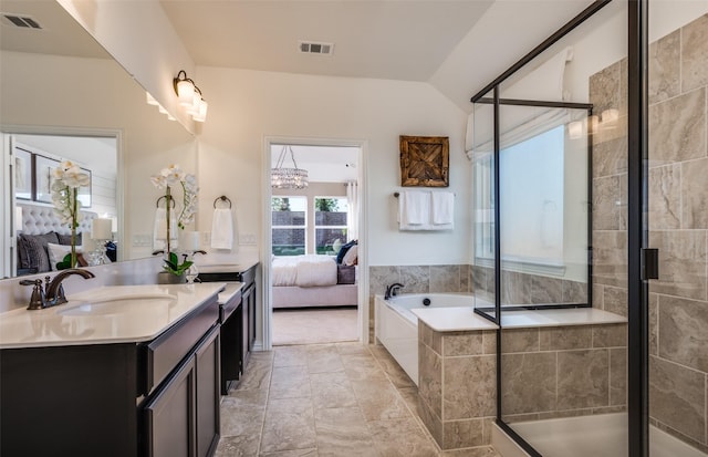ensuite bathroom featuring vanity, a stall shower, visible vents, and ensuite bath