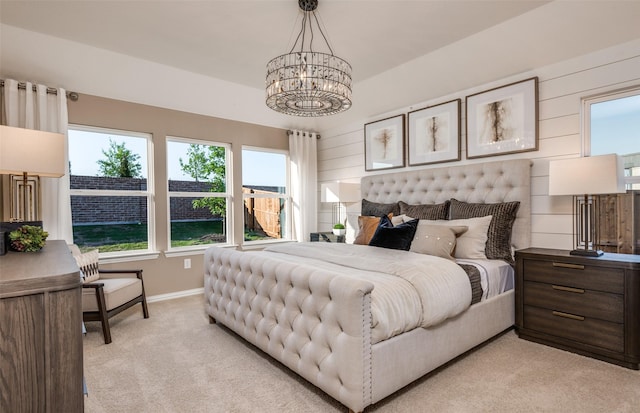 bedroom featuring a chandelier, baseboards, light colored carpet, and multiple windows