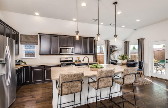 kitchen with a sink, dark wood-style floors, a wealth of natural light, and stainless steel appliances