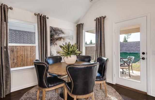 dining space featuring baseboards, vaulted ceiling, and dark wood-type flooring