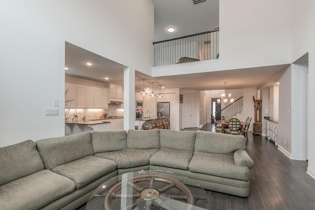 6256 Whitebrush Pl, Fort Worth, TX 76123 - living room featuring a high ceiling, a chandelier, recessed lighting, baseboards, and dark wood-type flooring