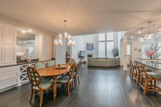 6256 Whitebrush Pl, Fort Worth, TX 76123 - dining area with an inviting chandelier, a fireplace, recessed lighting, and dark wood-style floors