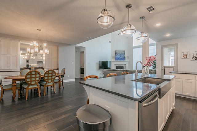 6256 Whitebrush Pl, Fort Worth, TX 76123 - kitchen featuring dark countertops, an inviting chandelier, a sink, visible vents, and a center island with sink