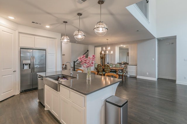 6256 Whitebrush Pl, Fort Worth, TX 76123 - kitchen with a kitchen island with sink, dark wood-style flooring, appliances with stainless steel finishes, a sink, and white cabinetry