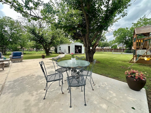 1346 Hillcrest Dr, Graham, TX 76450 - view of patio / terrace with a fenced backyard, an outbuilding, outdoor dining space, and a playground