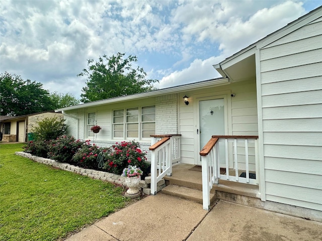 1346 Hillcrest Dr, Graham, TX 76450 - view of exterior entry featuring a lawn