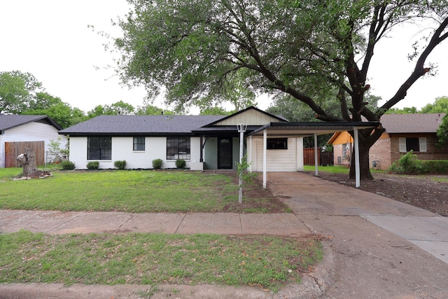 ranch-style home featuring a front yard, driveway, and an attached carport