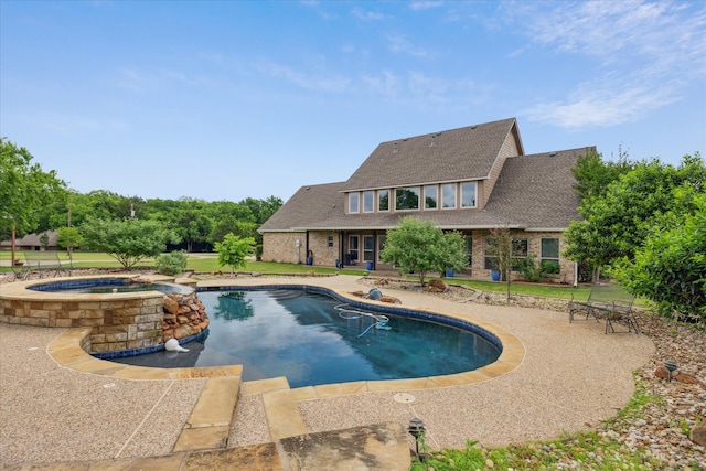 outdoor pool featuring a patio and an in ground hot tub