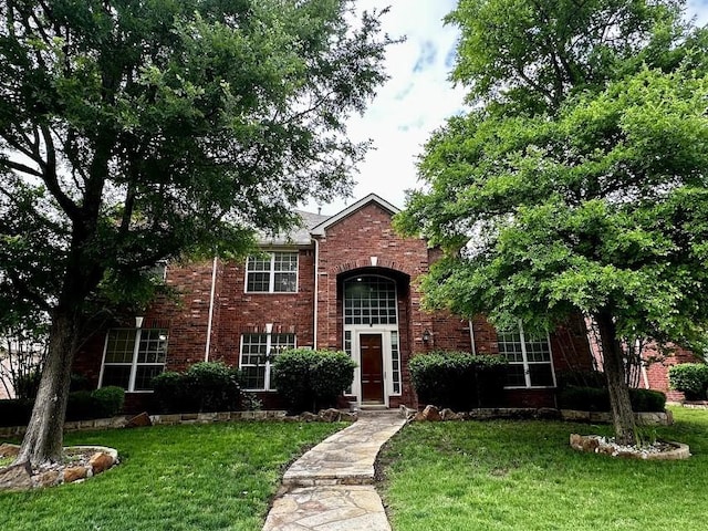 4605 Stargazer Dr, Plano, TX 75024 - traditional-style house with brick siding and a front yard