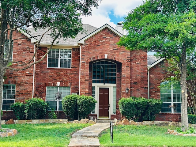 4605 Stargazer Dr, Plano, TX 75024 - traditional home with a chimney, a front yard, roof with shingles, and brick siding