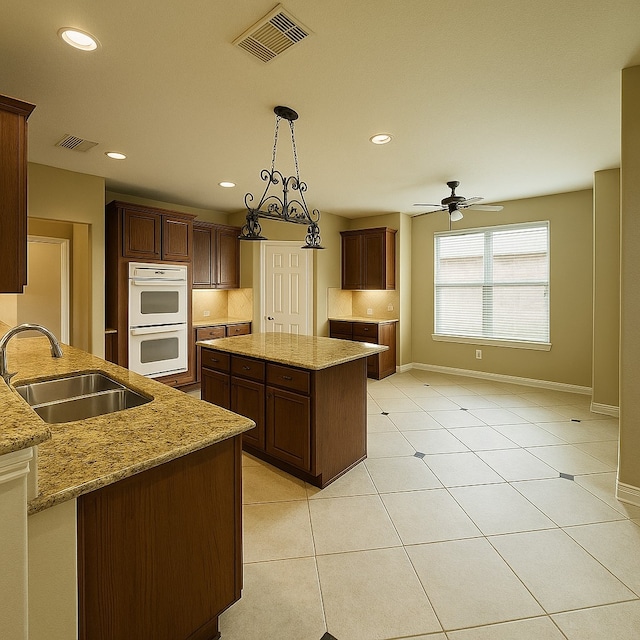 4605 Stargazer Dr, Plano, TX 75024 - kitchen featuring baseboards, visible vents, white double oven, and a sink
