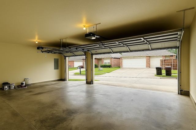 4605 Stargazer Dr, Plano, TX 75024 - garage featuring baseboards, a garage door opener, and electric panel