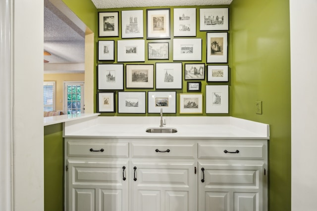 interior space featuring a textured ceiling and a sink