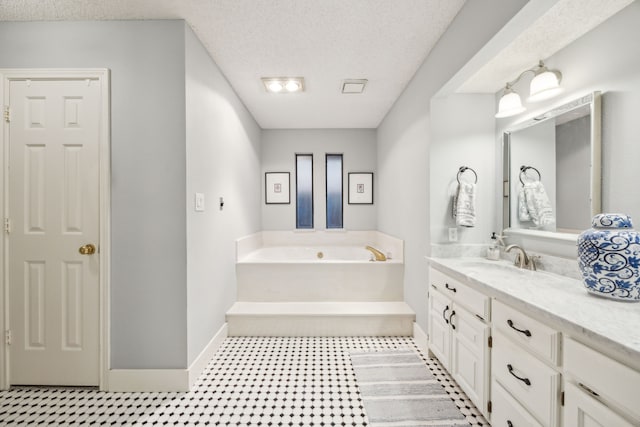 full bathroom with baseboards, a bath, and vanity