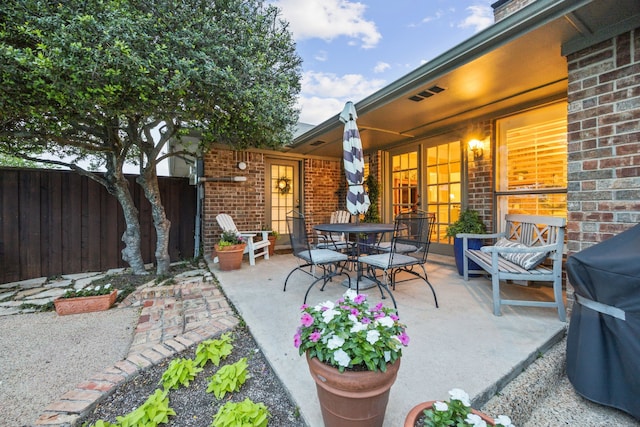 view of patio / terrace with fence, outdoor dining space, and grilling area