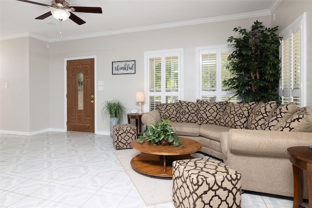 living area featuring baseboards, ornamental molding, and ceiling fan
