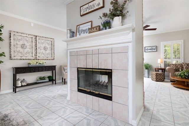 interior details with ornamental molding, a fireplace, and a ceiling fan