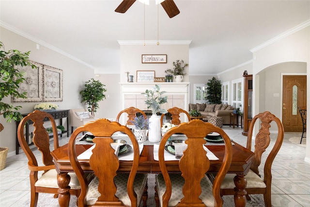 dining room with baseboards, ceiling fan, ornamental molding, and light tile patterned floors