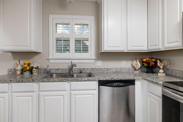kitchen with white cabinets, appliances with stainless steel finishes, and a sink
