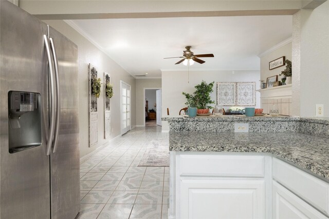 kitchen featuring ceiling fan, stainless steel refrigerator with ice dispenser, crown molding, light stone counters, and white cabinetry