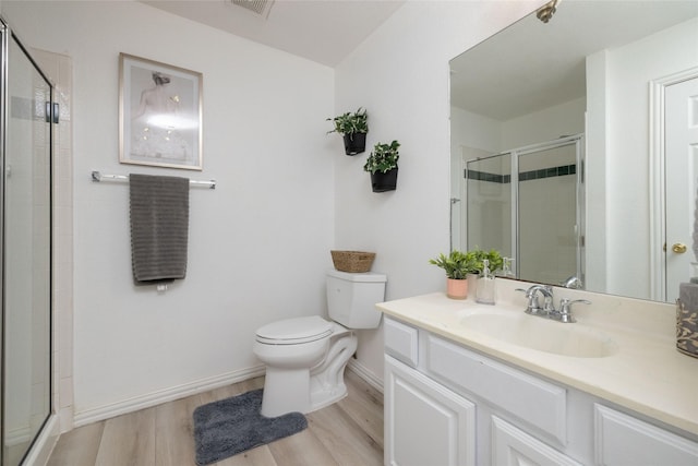 3130 Cimmaron Rd, Weatherford, TX 76087 - full bathroom featuring toilet, a shower stall, vanity, wood finished floors, and baseboards