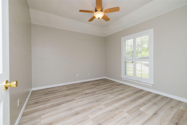 unfurnished room with a ceiling fan, baseboards, and wood finished floors