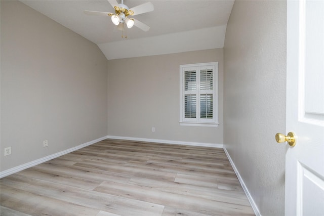 unfurnished room with a ceiling fan, baseboards, wood finished floors, and lofted ceiling