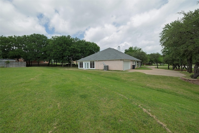 3130 Cimmaron Rd, Weatherford, TX 76087 - view of property exterior with concrete driveway, an attached garage, and central AC