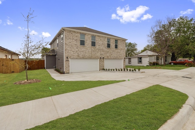 view of front facade featuring fence, an attached garage, brick siding, a front yard, and driveway