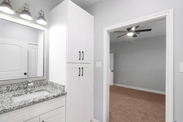 bathroom featuring vanity, baseboards, and ceiling fan