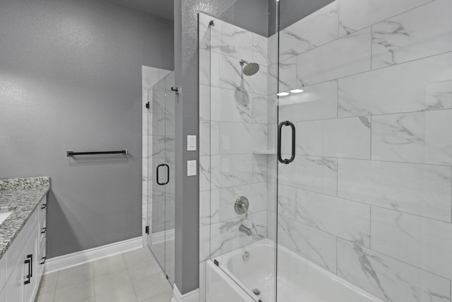 bathroom with vanity, bath / shower combo with glass door, and baseboards