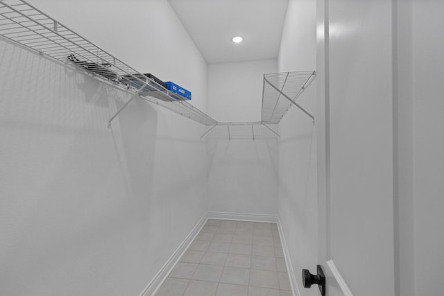walk in closet with light tile patterned flooring