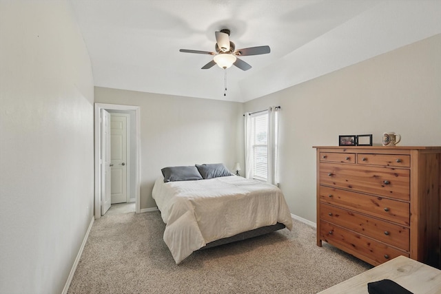 bedroom featuring baseboards, ceiling fan, and light carpet