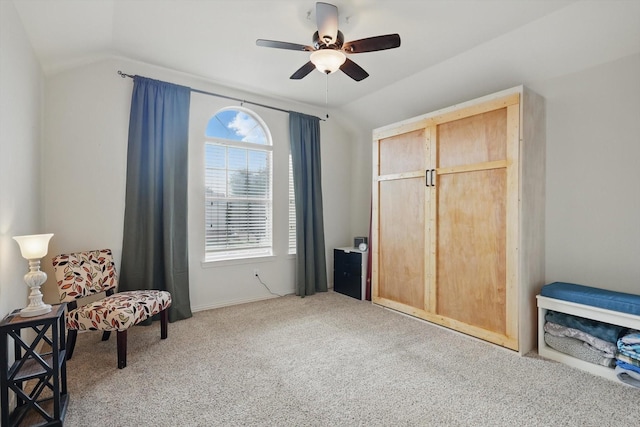 living area with carpet floors, a ceiling fan, baseboards, and vaulted ceiling
