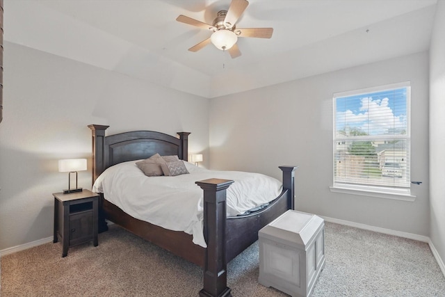 bedroom with a ceiling fan, baseboards, and light colored carpet