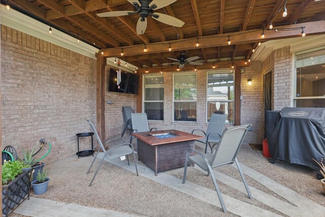 view of patio / terrace featuring a ceiling fan, a grill, and a fire pit