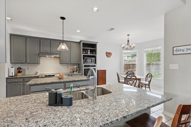 kitchen featuring ceiling fan, a sink, visible vents, dishwasher, and gray cabinetry