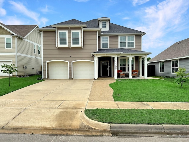 2309 Bray Village Dr, Denton, TX 76207 - view of front of house featuring a porch, an attached garage, driveway, and a front yard