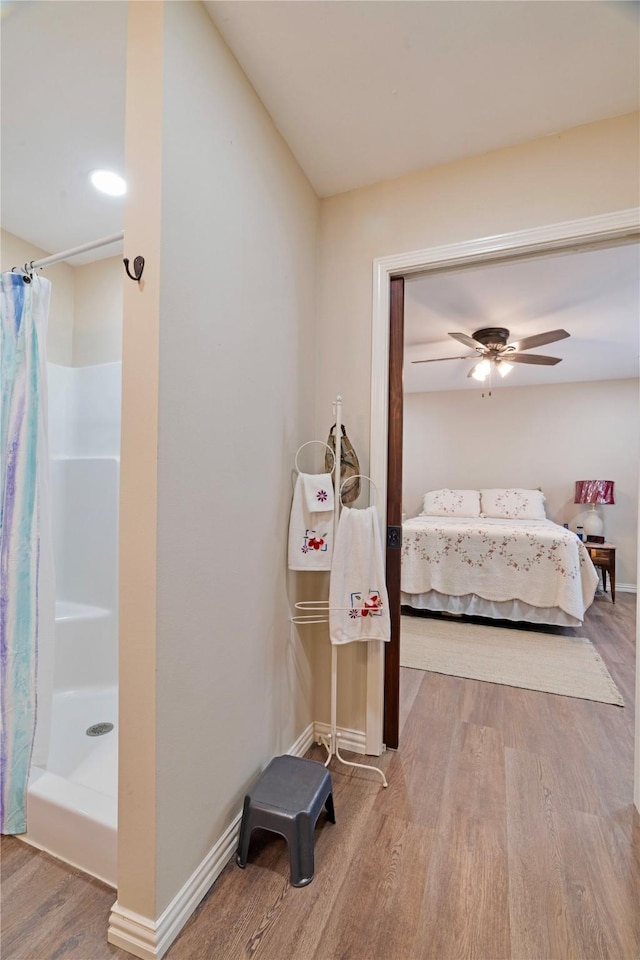 bedroom with baseboards and wood finished floors