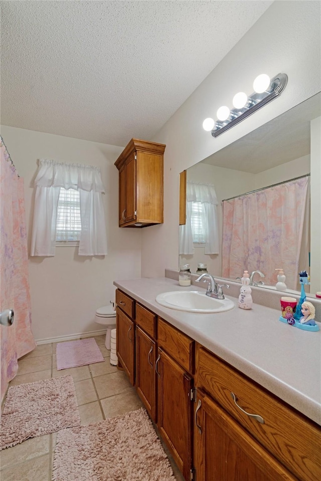 full bath featuring toilet, a textured ceiling, tile patterned flooring, and vanity