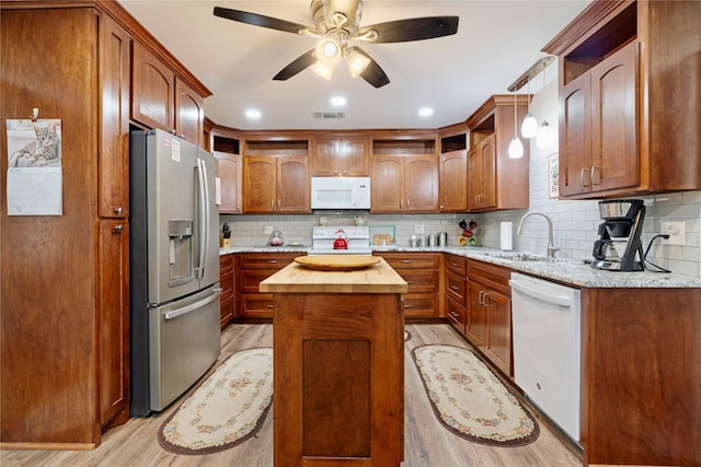 kitchen with open shelves, a sink, white appliances, butcher block countertops, and visible vents