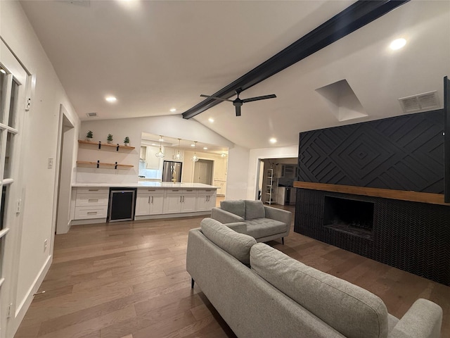 433 Fieldwood Dr, Richardson, TX 75081 - living area featuring a fireplace, light wood-style floors, wine cooler, recessed lighting, and ceiling fan