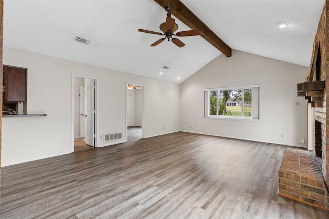 unfurnished living room with visible vents, ceiling fan, wood finished floors, and a fireplace