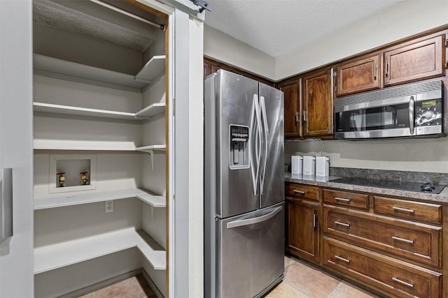 kitchen featuring visible vents, white dishwasher, a sink, and dark countertops