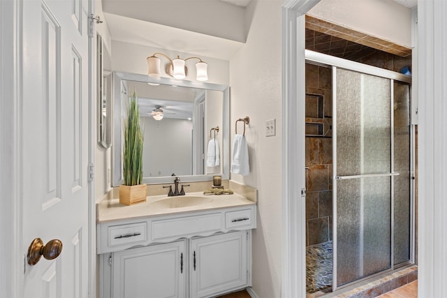 full bath featuring vanity, a ceiling fan, and a shower stall