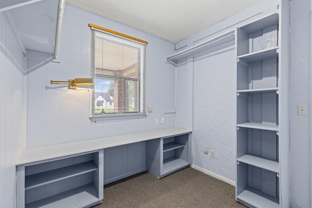 empty room with a textured ceiling, baseboards, a ceiling fan, and wood finished floors