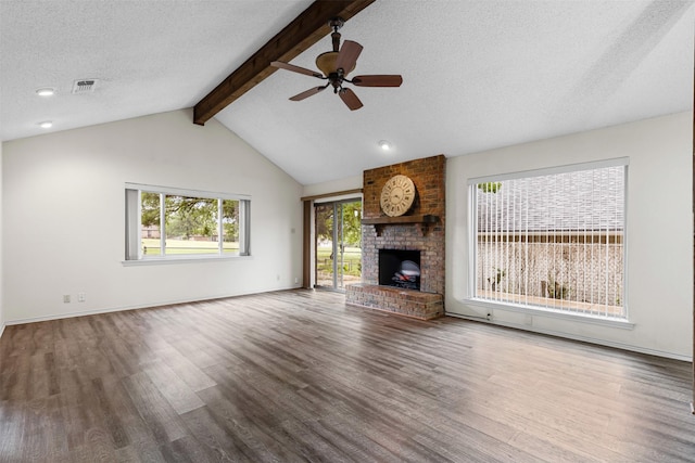 unfurnished living room featuring visible vents, ceiling fan with notable chandelier, a fireplace, and light wood-type flooring