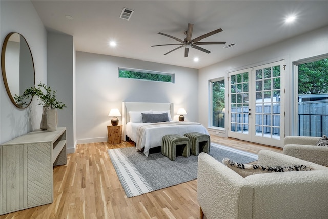 bedroom with visible vents, light wood-style floors, access to outside, and french doors