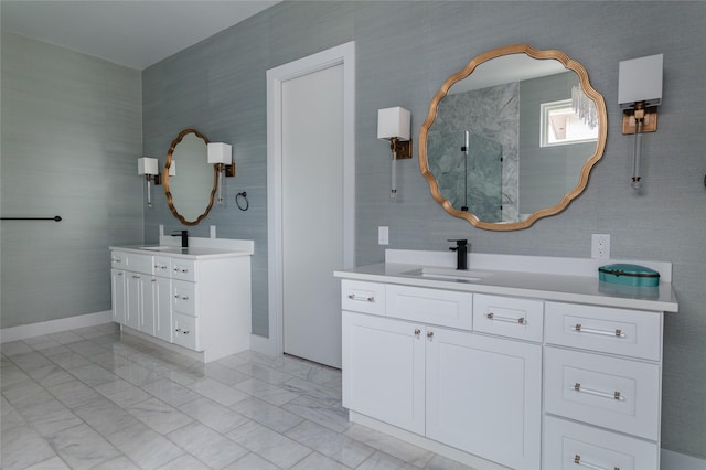 full bathroom featuring a sink, marble finish floor, walk in shower, and two vanities