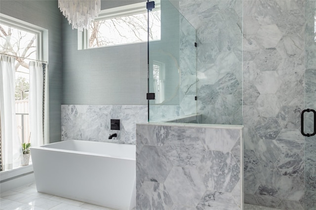 full bath featuring a shower with shower door and a freestanding bath